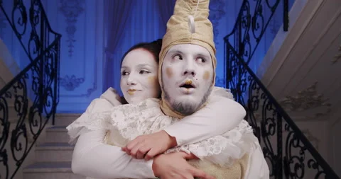 A made-up pair of dramatic mimes of a guy and a girl on a theatrical stage. The Stock Footage 166813084
