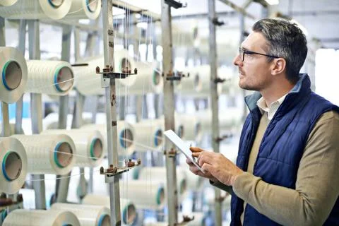 Made for strength. a man inspecting product in a plastics manufacturing plant. Stock Photos