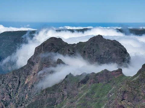Madeira Volcano Peaks in Rolling Clouds - Dramatic wide shot of dark, rugge.. Stock Photos