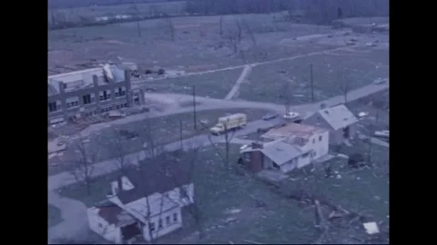 MADISON - 1974: Tornado Aftermath — Debris fire beside blistered roof Stock Footage 342230816