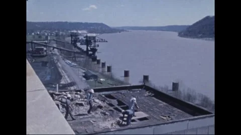 MADISON - 1974: Tornado Aftermath — Hard hats work on damaged plant roof 스톡 동영상 342229890