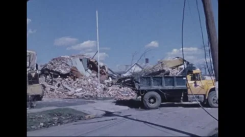 MADISON - 1974: Tornado Aftermath — Loaded dump trucks pass masonry mound Stock Footage 342230152