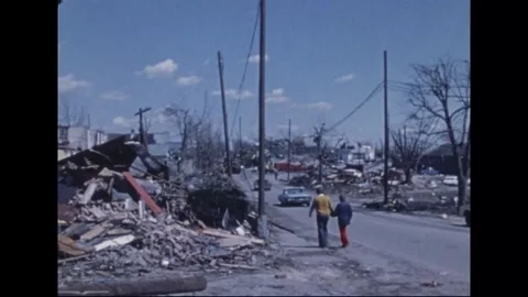 MADISON - 1974: Tornado Aftermath — Sedans crushed beneath brick and timber Stock Footage 342230035