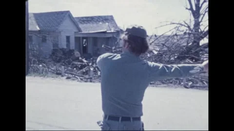 MADISON - 1974: Tornado Aftermath — Soldier signals with both arms out Stock Footage 342230361