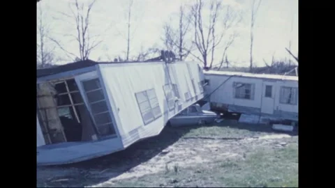 MADISON - 1974: Tornado Aftermath — Toppled mobile home crushes parked sedan Stock Footage 342230385