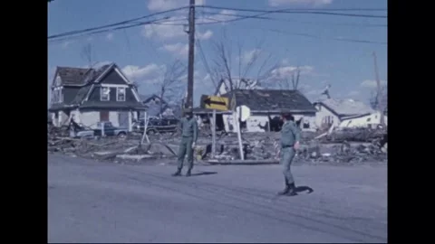 MADISON - 1974: Tornado Aftermath — Two soldiers take posts before ruined homes Stock Footage 342230312