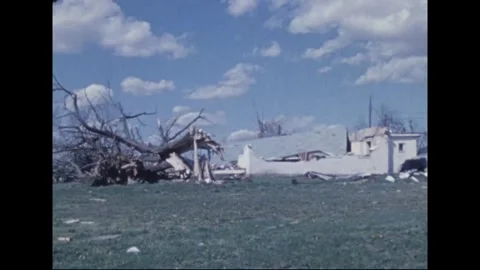 MADISON - 1974: Tornado Aftermath — Uprooted tree faces torn-open shops Stockbeeldmateriaal 342230381