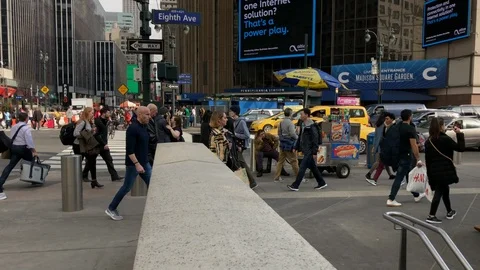 Madison Square Garden.
People and traffic moving along eighth avenue.
Pan Video stock 104831053
