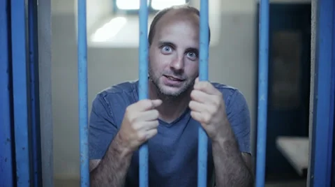 Madman cursing behind the bars 스톡 동영상 32326657