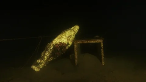 Madonna leaning against a table at the bottom of the lake, Albano lake, Italy Stock Footage 104581722