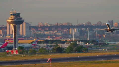 Madrid Barajas ATC control tower at sunset with Iberia and American Airlines Stock Footage 336404199