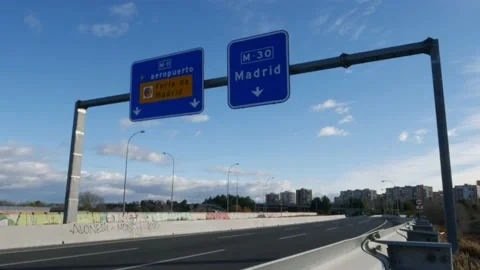 Madrid, Spain - Dec 5, 2021: Timelapse of motorway sign heading towards Madrid Stock Footage 166498302