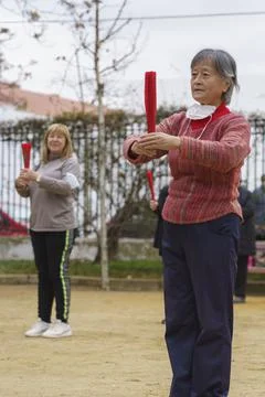 Madrid, Spain. February 27, 2022: Taichi teacher practicing with her students Stock Photos