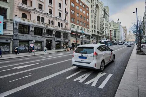 Madrid, Spain - June 03, 2023: A white taxi on a street in the city of Madrid Stock Photos
