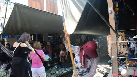 Mae klong Railway Market or Talat Rom Hup meaning the umbrella pulldown market Stock Footage