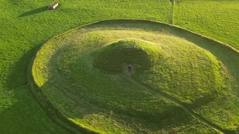 Maeshowe Tomb, Orkney, Drone Pull-Back Tilt-up Stunning Clip at Sunrise 4K Stock Footage 218037049