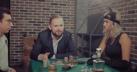 Mafiosi sit at the playing table, the man says. Gaming chips, alcohol, cigars Stock Footage 105882981