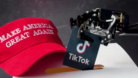 MAGA Hat and Robot Arm With Tiktok Card Stock Footage 278294488