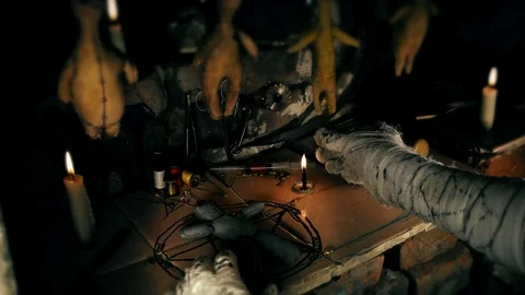The mage conducts a ritual with the voodoo doll Stock Footage