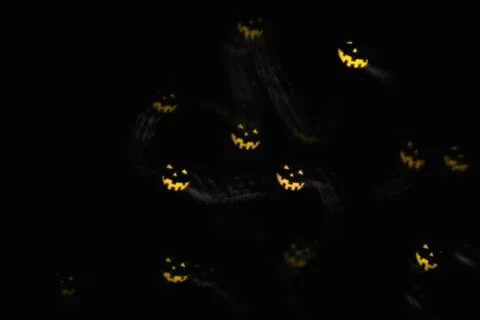 Magic background with colorful bokeh in shape of flying ghost  on black Stock Photos