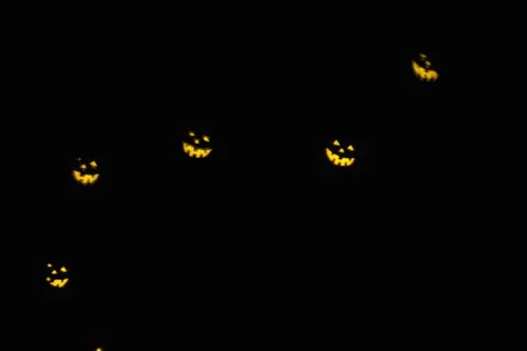 Magic background with colorful bokeh in shape of flying ghost  on black Foto stock