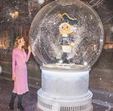 Magic ball with a nutcracker inside and a ballerina girl in a pink dress Stock Photos