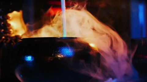 Magic cauldron with magic potion and smoke in a black cauldron. 스톡 동영상 285369384