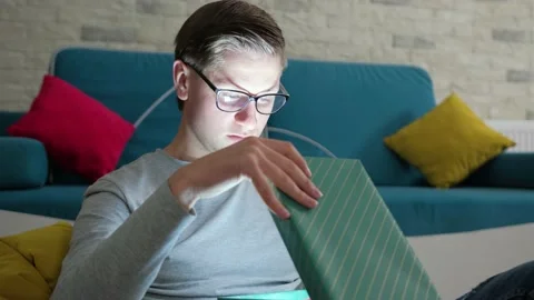 Magic concept - portrait of surprised young man opening gift box. Stock Footage 146612119