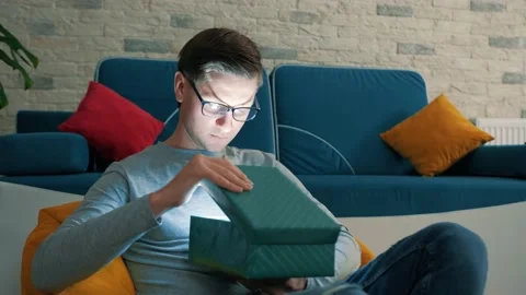 Magic concept - portrait of surprised young man opening gift box. Stock Footage 146802633