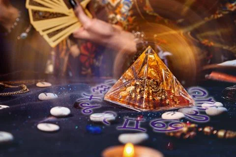 Magic divination and esotericism. Magic glass pyramid with a magical glow Stock Photos
