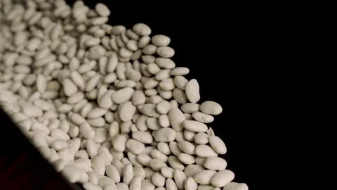Magic emergence of white beans on black background reversed 4k 10bit Stockbeeldmateriaal 332627299
