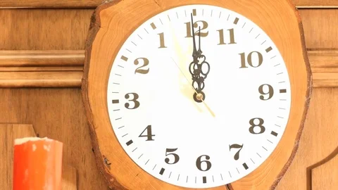 Magic fire appearance on candle with ticking clock background Video stock 83487175
