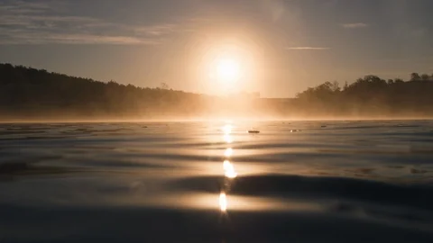 Magic fog hovering over water in golden light 4K Stock Footage 128506225