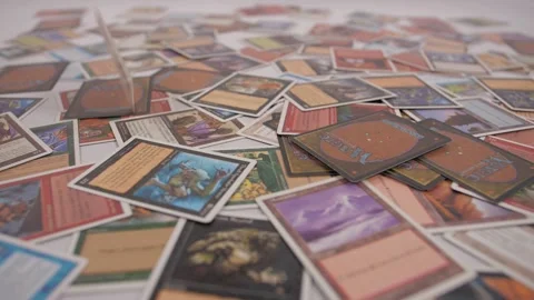 Magic the gathering cards falling on table Stockbeeldmateriaal 143446019