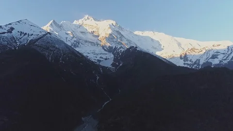 Magic glow on snow giant mountain peak above dark slopes Stock Footage 124682886