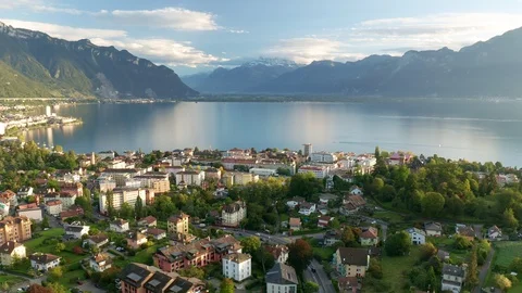 Magic hour aerial lateral shot of Switzerland Montreux with view to Lake Geneva Stock Footage 123711214