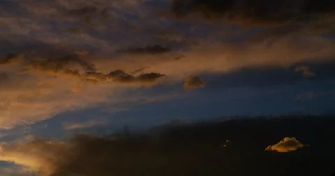 Magic hour with richly saturated clouds that comes with the gathering darkness. Stock-Fotos