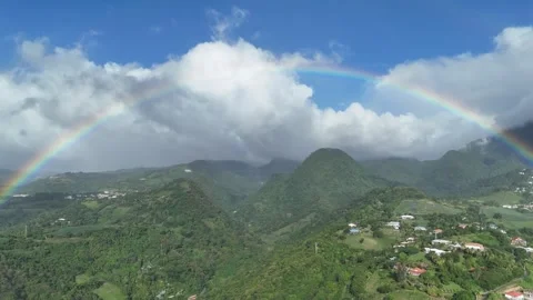 Magic hour in Saint-Pierre: Drone captures rainbow crowning lush valleys Stock Footage 306953934