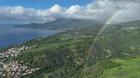 Magic hour in Saint-Pierre: Drone captures rainbow crowning lush valleys Video stock 306953947