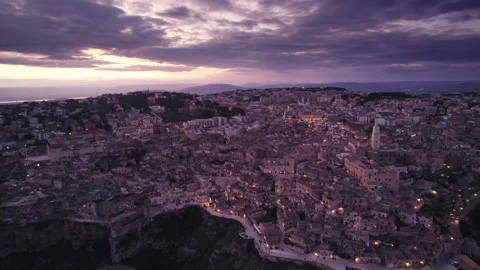 Magic hour sunset aerial over the Ancient Jerusalem looking city of Matera Stock Footage 241172980