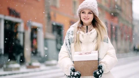 Magic moment young beautiful blonde woman walking outdoors with christmas Stock Footage 146755229