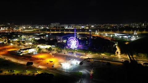 Magic of the Night: Drone Flight over the City with a Ferris Wheel Video stock 242651441