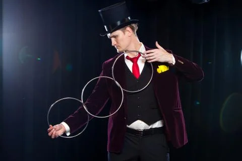 Magic, performance, circus, show concept - magician in top hat showing trick Stock Photos