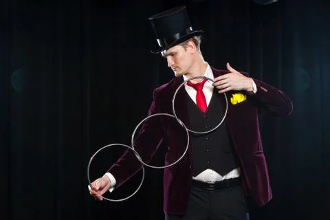 Magic, performance, circus, show concept - magician in top hat showing trick Stock Photos