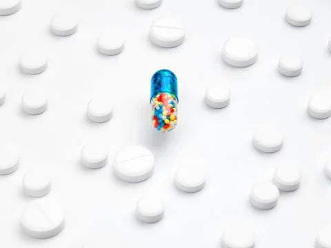 Magic pill concept. A large tablet capsule with multi-colored filling is in the Stock Photos