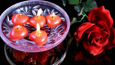 Magic ritual with red floating burning candles in glass bowl with water Stock Footage 155664910