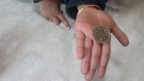 Magic show of disappearing coin in front of baby purse Stock Footage 100858983