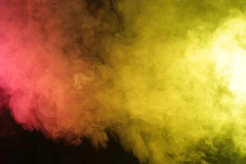 Magic Smoke in red-yellow light on black background Stock Photos
