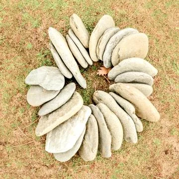 Magic stone circle shape on grass background, light pebbles Stock Photos