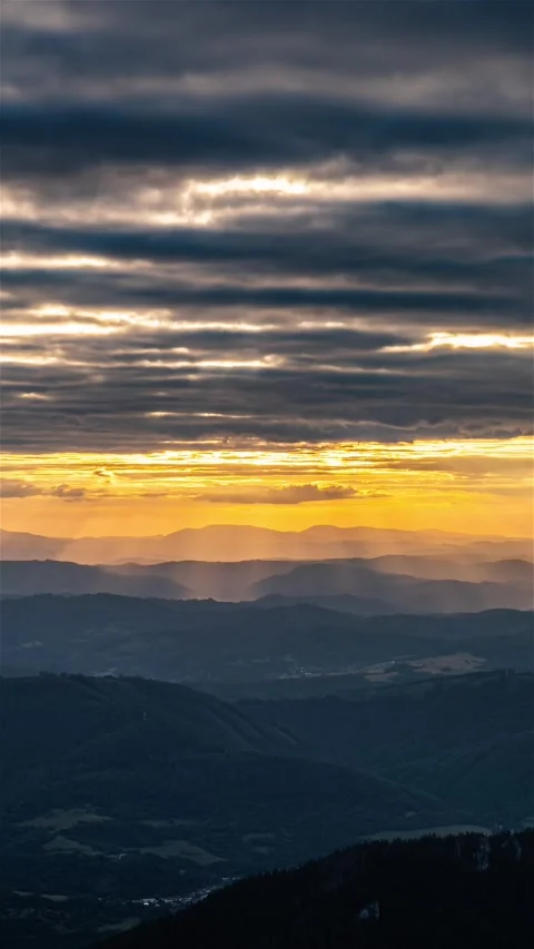 Magic Sunset with Rays of the Sun Shining Through Clouds Over Mountains Stock Footage 316260439